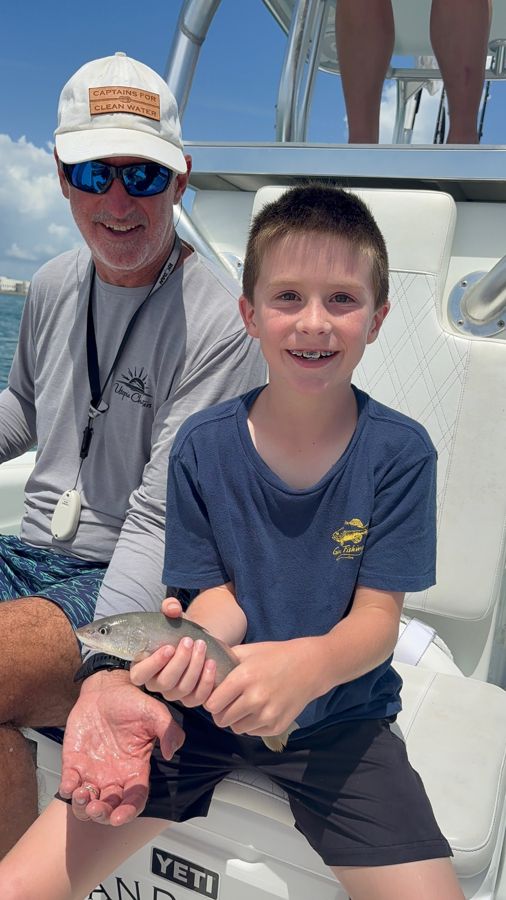Captain Craig and a young guest with his catch