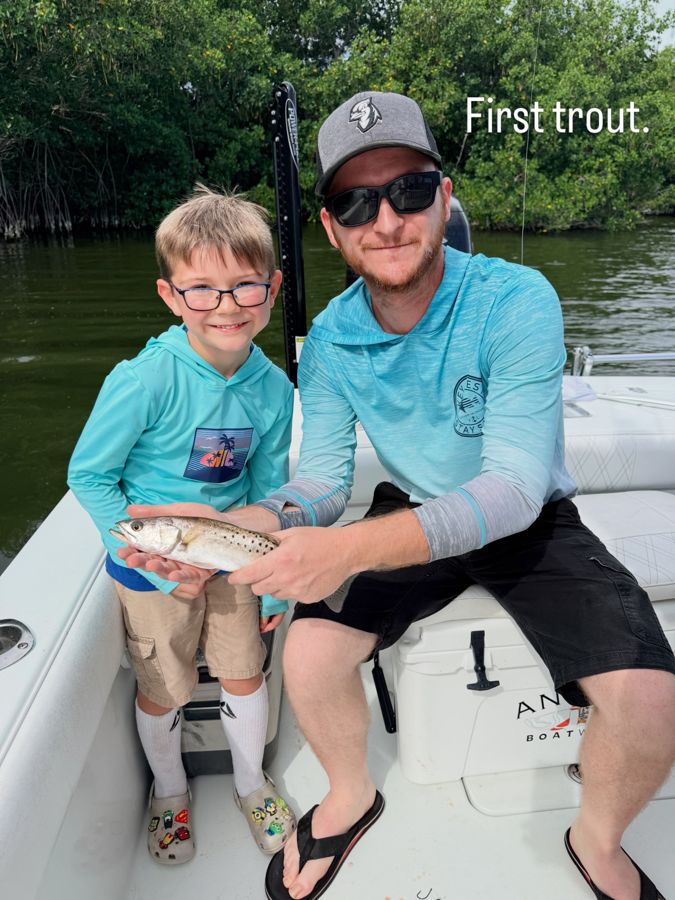 A young angler's first trout with his dad in the mangroves